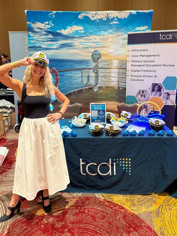 Connie Smith in front of TCDI's table during ACC S. Florida's Annual CLE Conference