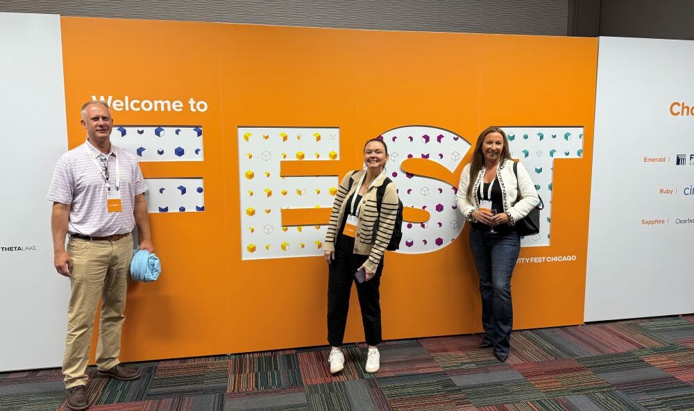 TCDI Team standing in front of FEST sign at RelFest 2025